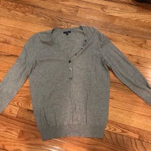 Grey sweater with button details.